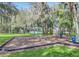 Community playground with swings and play equipment, nestled among mature trees and green lawns at 2767 Aragon Ter, Lake Mary, FL 32746