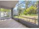 Relaxing screened porch features wood-look tile flooring and beautiful views of the landscaped backyard at 2767 Aragon Ter, Lake Mary, FL 32746
