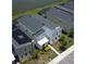 An aerial view showcases this modern home with solar panels and access to a lake at 2855 Bookmark Dr, Kissimmee, FL 34746
