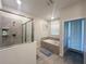 Bathroom with tiled shower, soaking tub, tile floor, and outdoor access at 2855 Bookmark Dr, Kissimmee, FL 34746