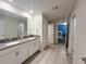 The bathroom features double sinks, a walk-in shower, and an entry to another room at 2855 Bookmark Dr, Kissimmee, FL 34746