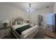 Bright bedroom featuring a chandelier, comfortable bed, and coordinated decor at 2855 Bookmark Dr, Kissimmee, FL 34746