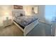 The primary bedroom is furnished with a queen bed, lamps, and a dresser at 2855 Bookmark Dr, Kissimmee, FL 34746