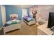 bedroom with carpet, two twin beds and 'Frozen' character wall art at 2855 Bookmark Dr, Kissimmee, FL 34746
