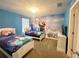 bedroom with carpet, two twin beds and 'Frozen' themed mural at 2855 Bookmark Dr, Kissimmee, FL 34746