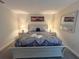 Bright bedroom featuring a bed with decorative patterned bedding and symmetrical nightstands with lamps at 2855 Bookmark Dr, Kissimmee, FL 34746