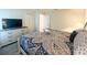 Comfortable bedroom with large bed, dresser with television, and neutral color scheme at 2855 Bookmark Dr, Kissimmee, FL 34746