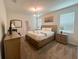 Well-lit bedroom features carpeted floors, a large bed, and stylish furnishings at 2855 Bookmark Dr, Kissimmee, FL 34746