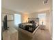 The neutral bedroom has a queen bed, lamps, dresser and a window at 2855 Bookmark Dr, Kissimmee, FL 34746