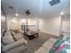 Open bonus room featuring neutral carpet, large sofas, coffee table and access to multiple rooms at 2855 Bookmark Dr, Kissimmee, FL 34746