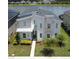 A modern home with stone accents is showcased in an aerial view with lush landscaping at 2855 Bookmark Dr, Kissimmee, FL 34746