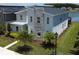 Modern home with stone accents and lush landscaping near a lake, captured in an aerial shot at 2855 Bookmark Dr, Kissimmee, FL 34746