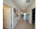 Bright hallway with neutral tile flooring and stylish artwork leading to the main living areas at 2855 Bookmark Dr, Kissimmee, FL 34746