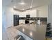 Modern kitchen with white cabinetry, stainless steel appliances, and a gray countertop island at 2855 Bookmark Dr, Kissimmee, FL 34746