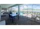 Covered patio featuring a pool, dining table, lounge seating, and a beautiful view of the lake at 2855 Bookmark Dr, Kissimmee, FL 34746