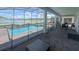 Screened-in pool area with lake view, featuring a pool, hot tub, and outdoor dining at 2855 Bookmark Dr, Kissimmee, FL 34746