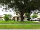 Charming home featuring a well-manicured lawn and mature trees providing ample shade at 3017 Lambath Road, Orlando, FL 32818