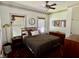 Cozy bedroom featuring a wooden bed frame, ceiling fan, and unique decor and lots of natural light at 311 W 10Th St, Sanford, FL 32771