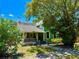 Charming two-story home with a welcoming covered front porch and a large tree adding curb appeal at 311 W 10Th St, Sanford, FL 32771