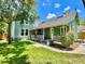 Charming exterior of a green home with a spacious porch and inviting curb appeal at 311 W 10Th St, Sanford, FL 32771