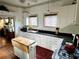 Well-lit kitchen with white cabinets, black countertops, and a mobile island at 311 W 10Th St, Sanford, FL 32771