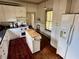 Open kitchen with a center island, great counter space, and ample natural light at 311 W 10Th St, Sanford, FL 32771
