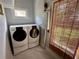 Functional laundry room with washer, dryer, and convenient storage solutions at 311 W 10Th St, Sanford, FL 32771
