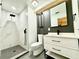 Modern bathroom with stylish vanity, framed mirror, and updated shower at 319 Halsey St, Orlando, FL 32839