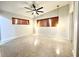Open bedroom with ceiling fan, terrazzo floors, and natural light at 319 Halsey St, Orlando, FL 32839