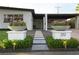 Inviting entryway featuring well-lit walkway, decorative planters, and attractive landscaping at 319 Halsey St, Orlando, FL 32839