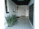 Covered front porch with well-lit walkway, decorative plants, and tiled floor at 319 Halsey St, Orlando, FL 32839