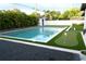 Backyard features a refreshing pool, putting green, and lush tropical landscaping at 319 Halsey St, Orlando, FL 32839