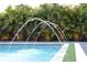 Close-up of a sparkling pool with water features and tropical landscaping at 319 Halsey St, Orlando, FL 32839