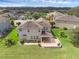 Gorgeous backyard with a covered patio and lush landscaping at 32004 Redtail Reserve Blvd, Sorrento, FL 32776
