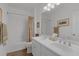 Bright bathroom features a double sink vanity, framed mirror, and shower-tub combination at 32004 Redtail Reserve Blvd, Sorrento, FL 32776