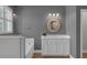 Bright bathroom featuring a white vanity, soaking tub, and separate glass enclosed shower at 32004 Redtail Reserve Blvd, Sorrento, FL 32776