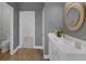 Bright bathroom with a white vanity, modern fixtures, and a view into a walk-in closet at 32004 Redtail Reserve Blvd, Sorrento, FL 32776