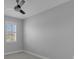 Bright bedroom with a window, ceiling fan, and neutral carpeting at 32004 Redtail Reserve Blvd, Sorrento, FL 32776
