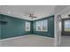 Bright bedroom featuring a ceiling fan, two windows with shutters, and neutral carpeting at 32004 Redtail Reserve Blvd, Sorrento, FL 32776