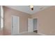 Comfortable bedroom with two doors, neutral walls and soft carpeting at 32004 Redtail Reserve Blvd, Sorrento, FL 32776