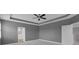 Bedroom featuring tray ceilings, neutral walls, and a view into the bright bathroom at 32004 Redtail Reserve Blvd, Sorrento, FL 32776