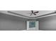 Bedroom featuring tray ceilings and a view into a teal-colored room at 32004 Redtail Reserve Blvd, Sorrento, FL 32776