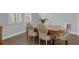 Cozy dining room featuring a wooden table and upholstered chairs, bathed in natural light at 32004 Redtail Reserve Blvd, Sorrento, FL 32776