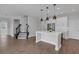 Spacious kitchen features a center island with pendant lighting, stainless appliances, and tile flooring at 32004 Redtail Reserve Blvd, Sorrento, FL 32776