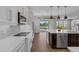 Stylish kitchen with a view to the outdoor space, features white cabinets, stainless appliances, and a center island at 32004 Redtail Reserve Blvd, Sorrento, FL 32776