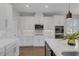 Well-lit kitchen featuring stainless steel appliances, white cabinetry, and modern finishes at 32004 Redtail Reserve Blvd, Sorrento, FL 32776
