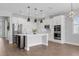 Modern kitchen with white cabinets, stainless steel appliances, a center island, and stylish pendant lighting at 32004 Redtail Reserve Blvd, Sorrento, FL 32776