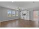 The spacious living room boasts recessed lighting, a ceiling fan and wood-look tile flooring at 32004 Redtail Reserve Blvd, Sorrento, FL 32776