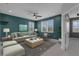 Bright living room with teal walls, modern furniture, and ample natural light through shuttered windows at 32004 Redtail Reserve Blvd, Sorrento, FL 32776