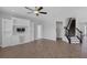 Open living area featuring built-in cabinets, tile floors, and a staircase with a decorative runner at 32004 Redtail Reserve Blvd, Sorrento, FL 32776